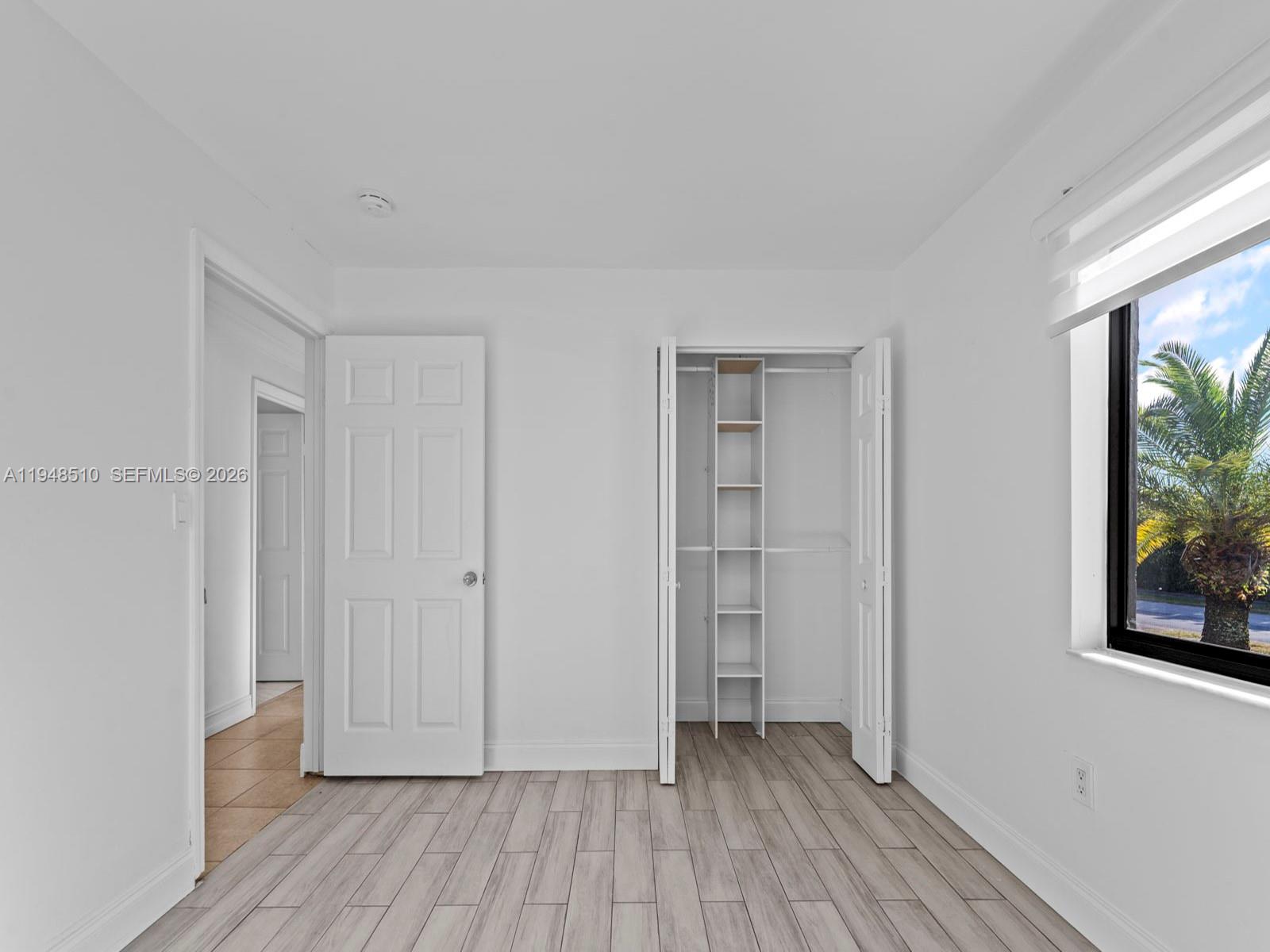 25921 Southwest 130th Avenue Homestead, FL 33032 - Photo 21 of 38 a view of a livingroom with wooden floor and window