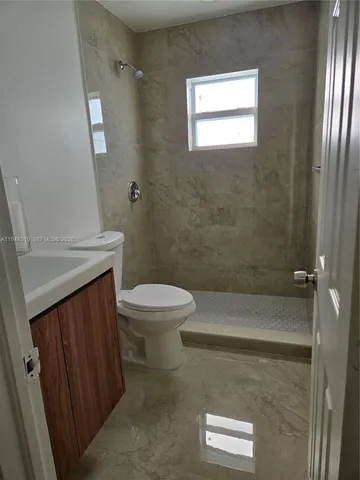 a bathroom with a toilet a sink and shower