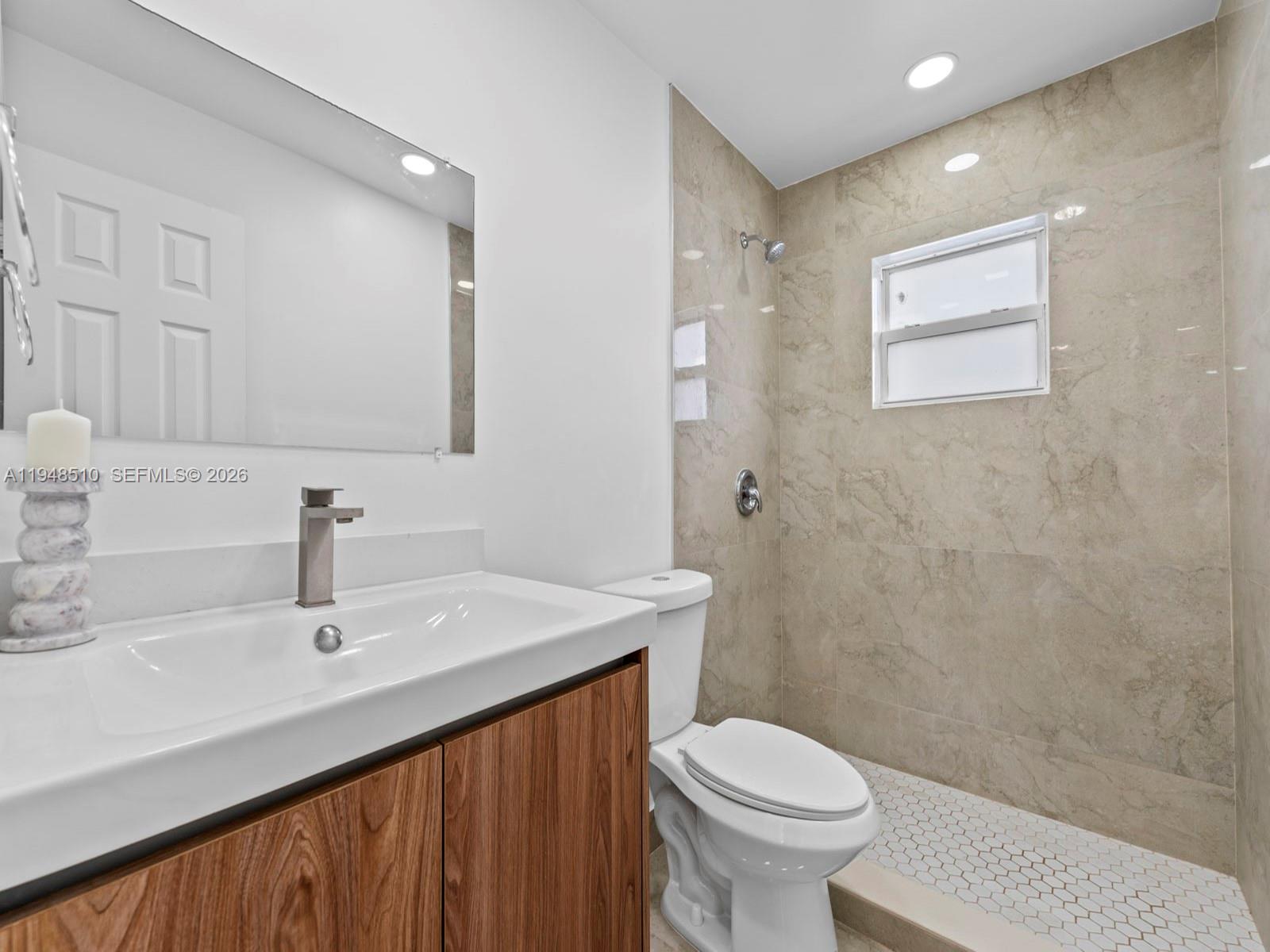 25921 Southwest 130th Avenue Homestead, FL 33032 - Photo 24 of 38 a bathroom with a sink a toilet and a mirror