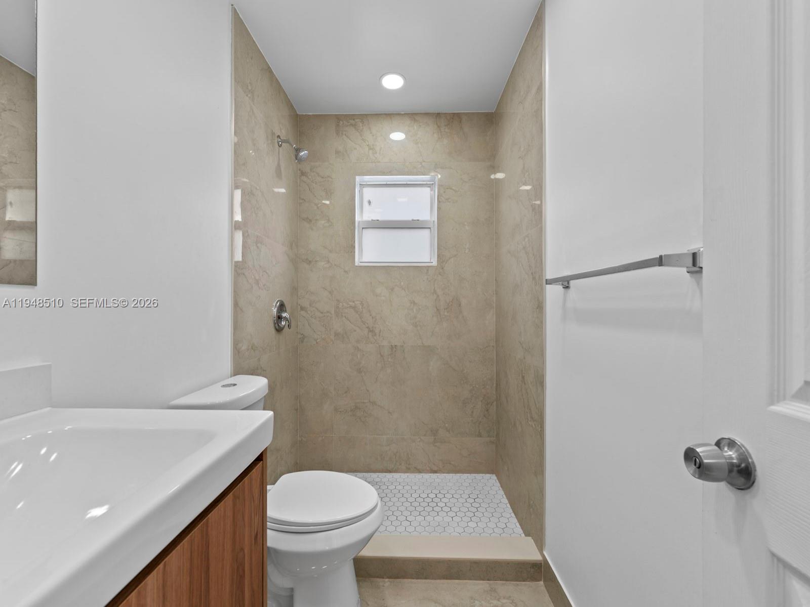 25921 Southwest 130th Avenue Homestead, FL 33032 - Photo 25 of 38 a white toilet sitting next to a bathroom sink and vanity