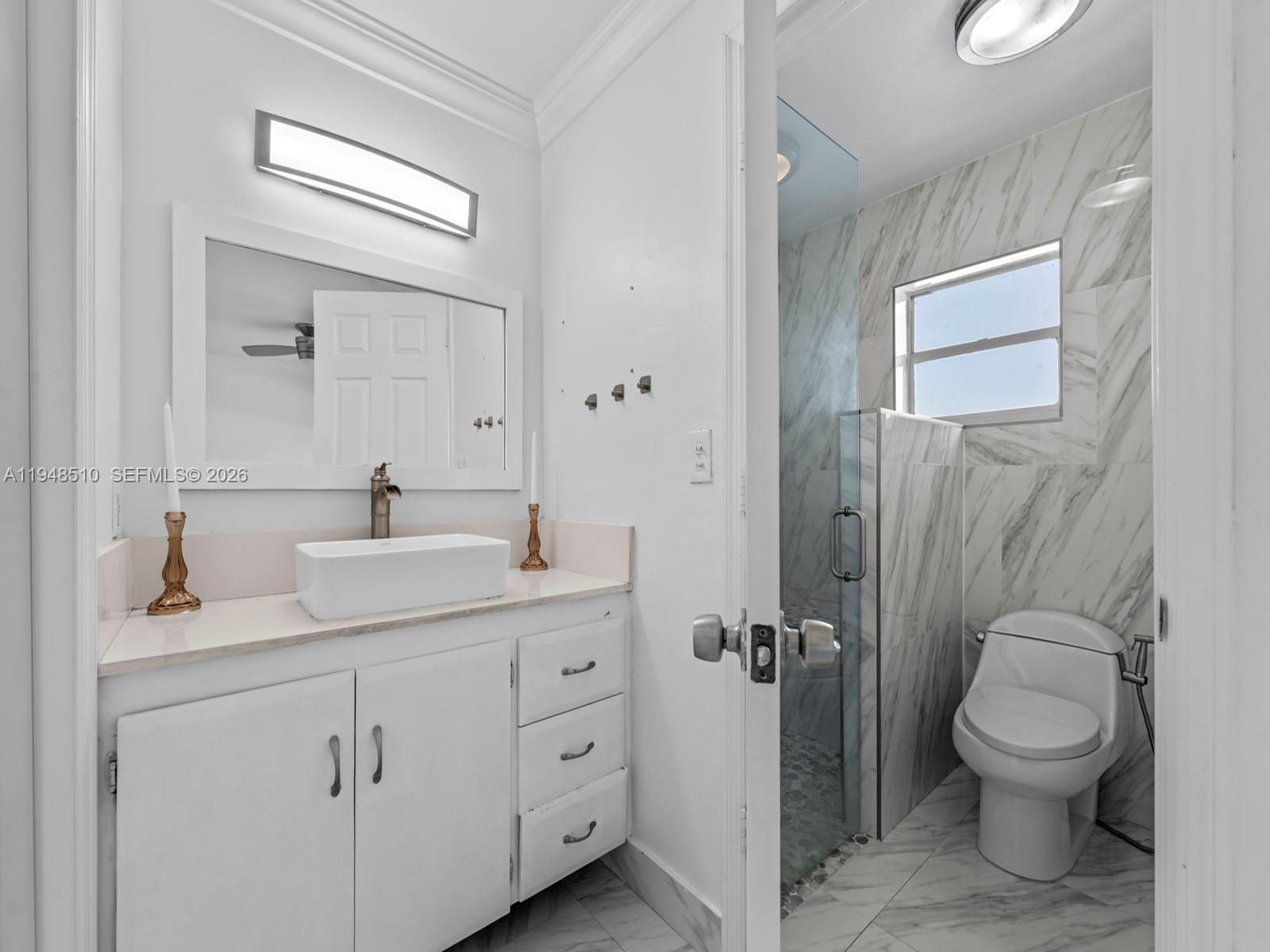 25921 Southwest 130th Avenue Homestead, FL 33032 - Photo 28 of 38 a bathroom with a granite countertop toilet sink and mirror