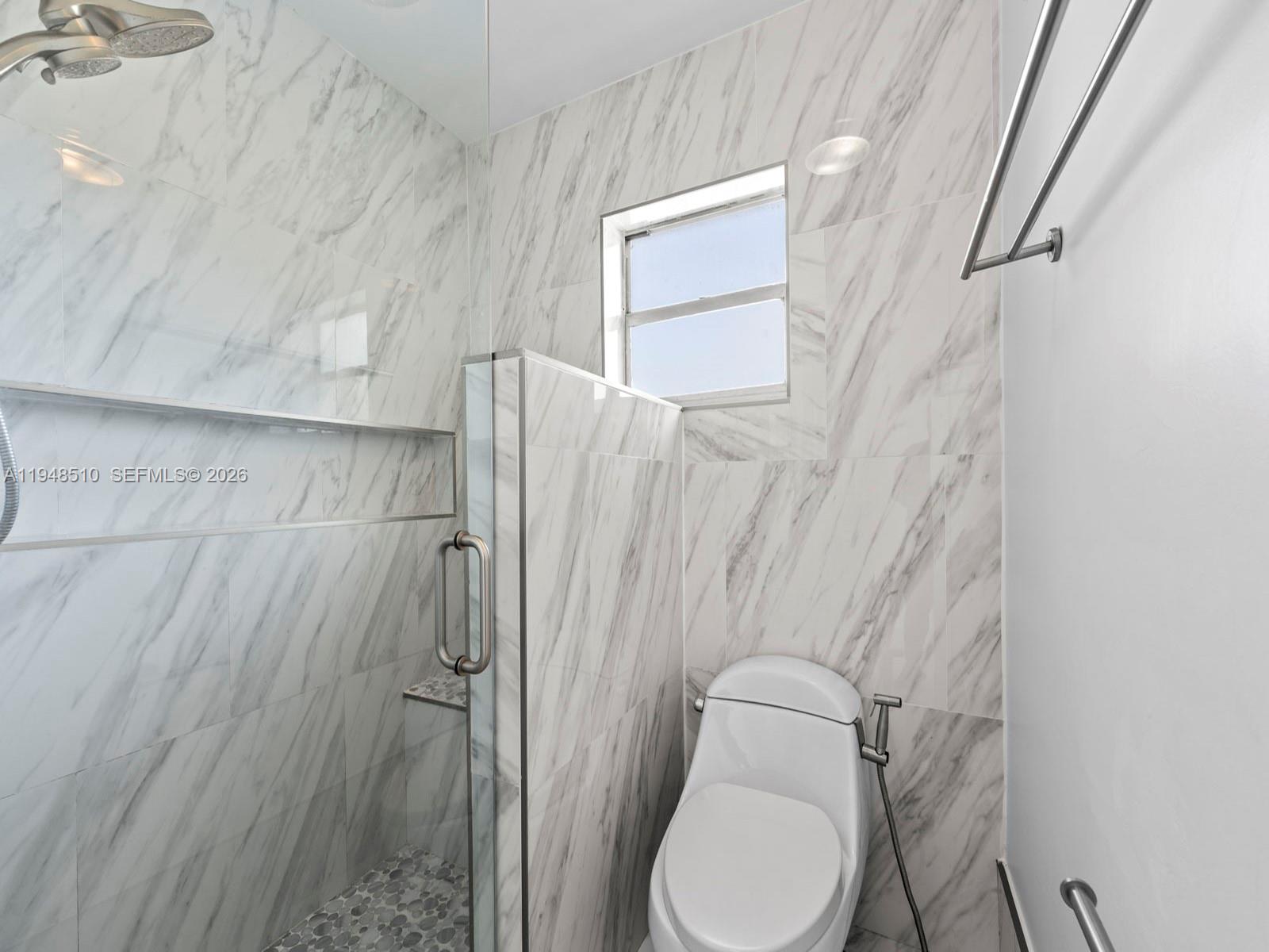 25921 Southwest 130th Avenue Homestead, FL 33032 - Photo 31 of 38 a bathroom with a toilet and a shower