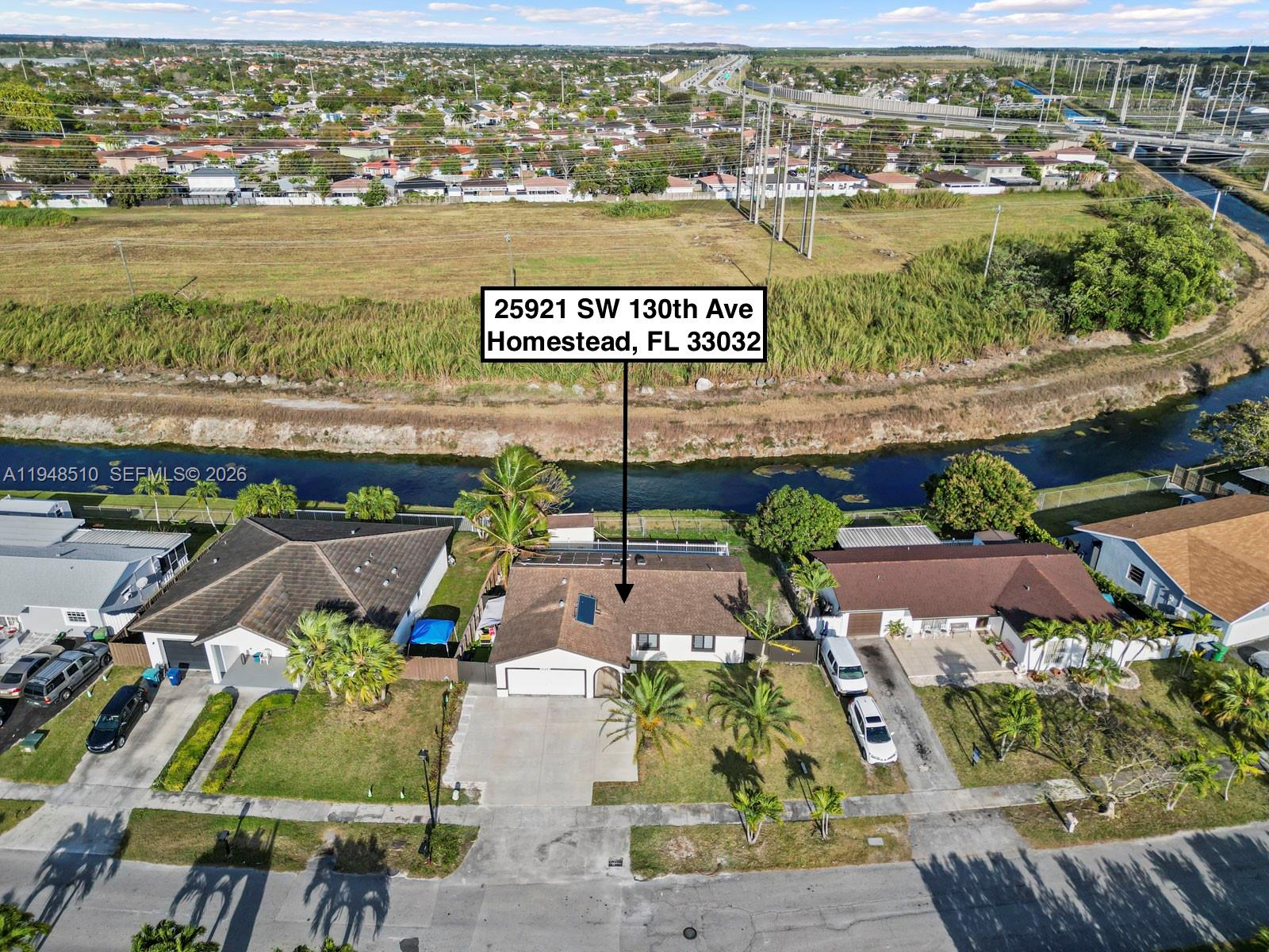 25921 Southwest 130th Avenue Homestead, FL 33032 - Photo 4 of 38 an aerial view of residential houses with outdoor space