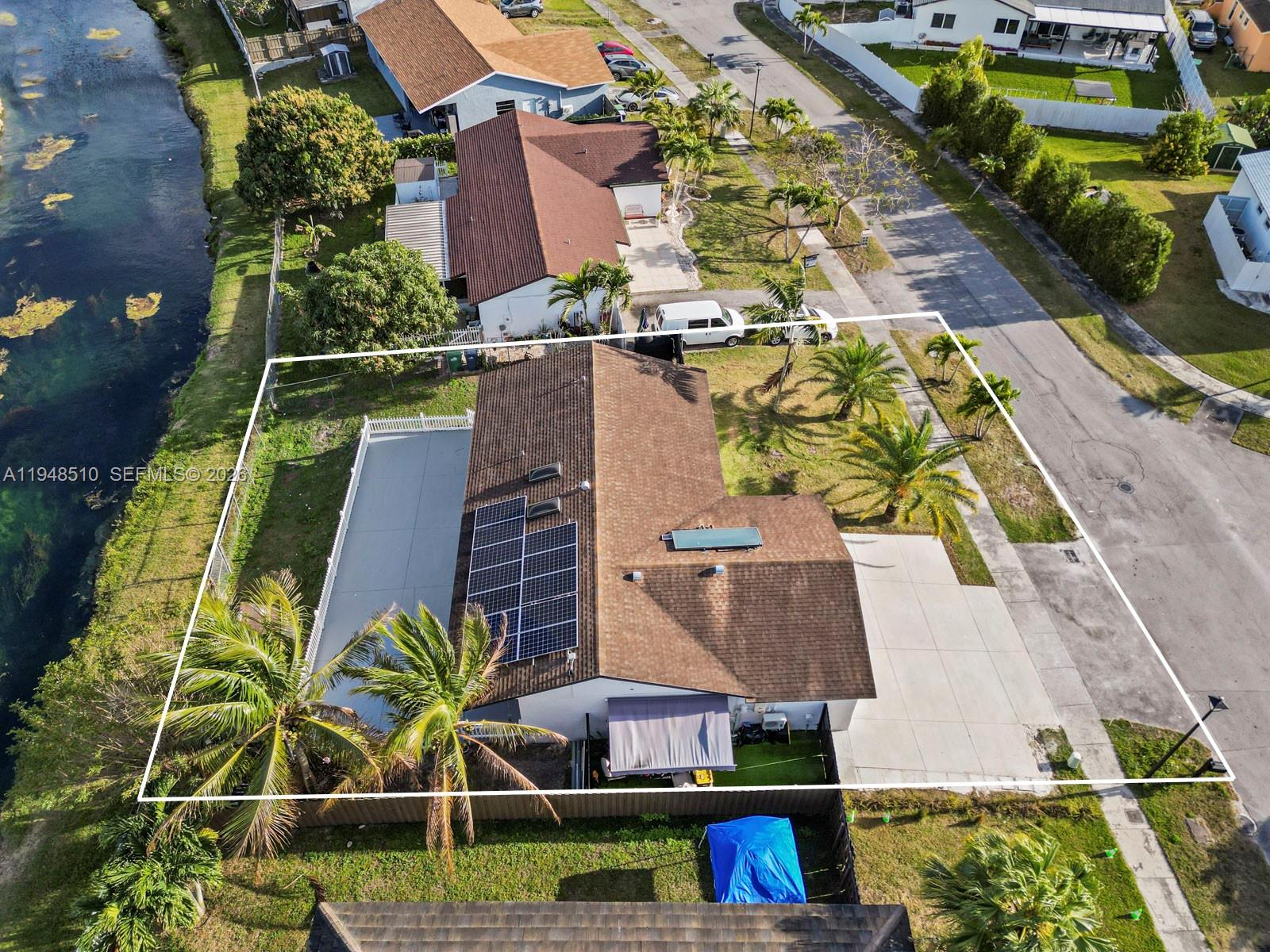 25921 Southwest 130th Avenue Homestead, FL 33032 - Photo 8 of 38 an aerial view of multiple houses with a yard