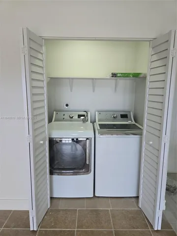 a utility room with washer and dryer