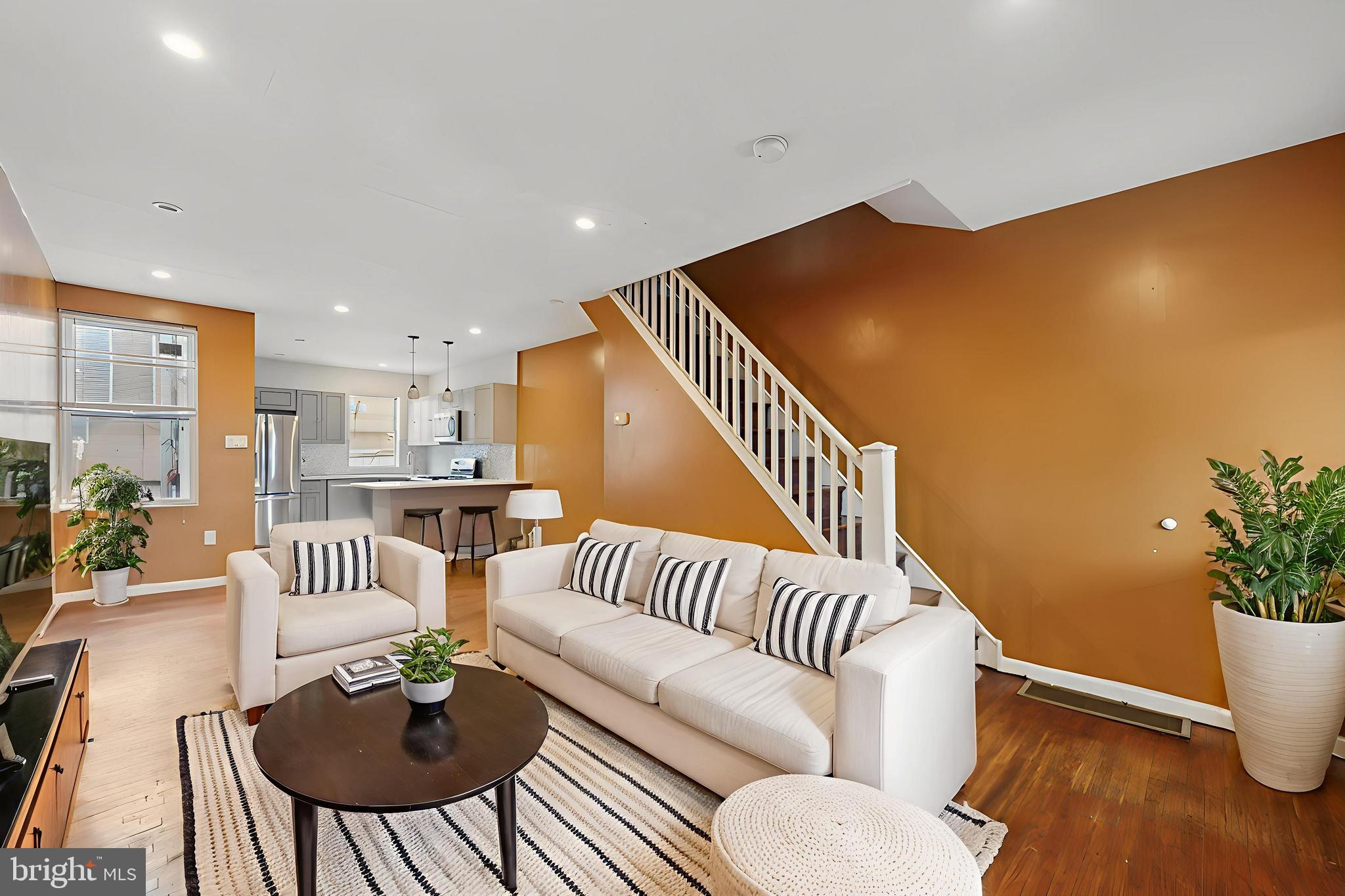 a living room with furniture and a potted plant