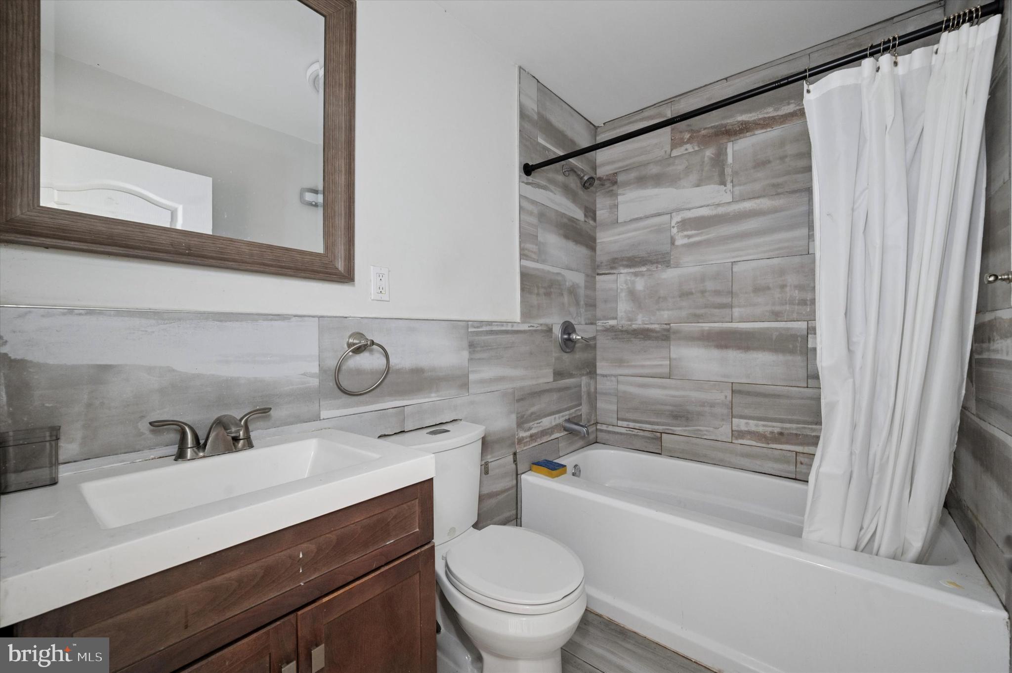 249 West Calvert Street Philadelphia, PA 19120 - Photo 16 of 25 a bathroom with a sink a toilet and a bathtub
