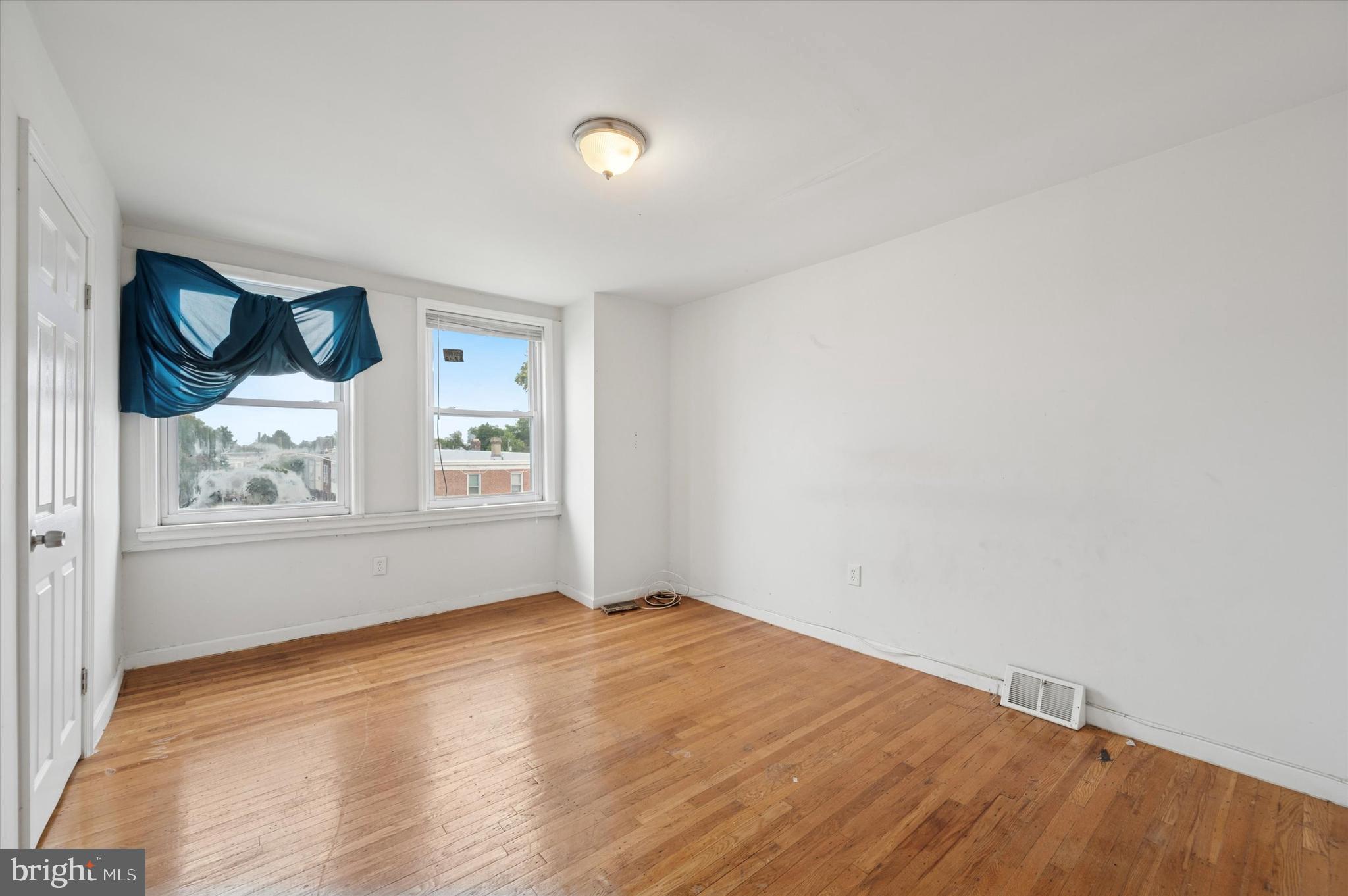 249 West Calvert Street Philadelphia, PA 19120 - Photo 17 of 25 an empty room with window and wooden floor