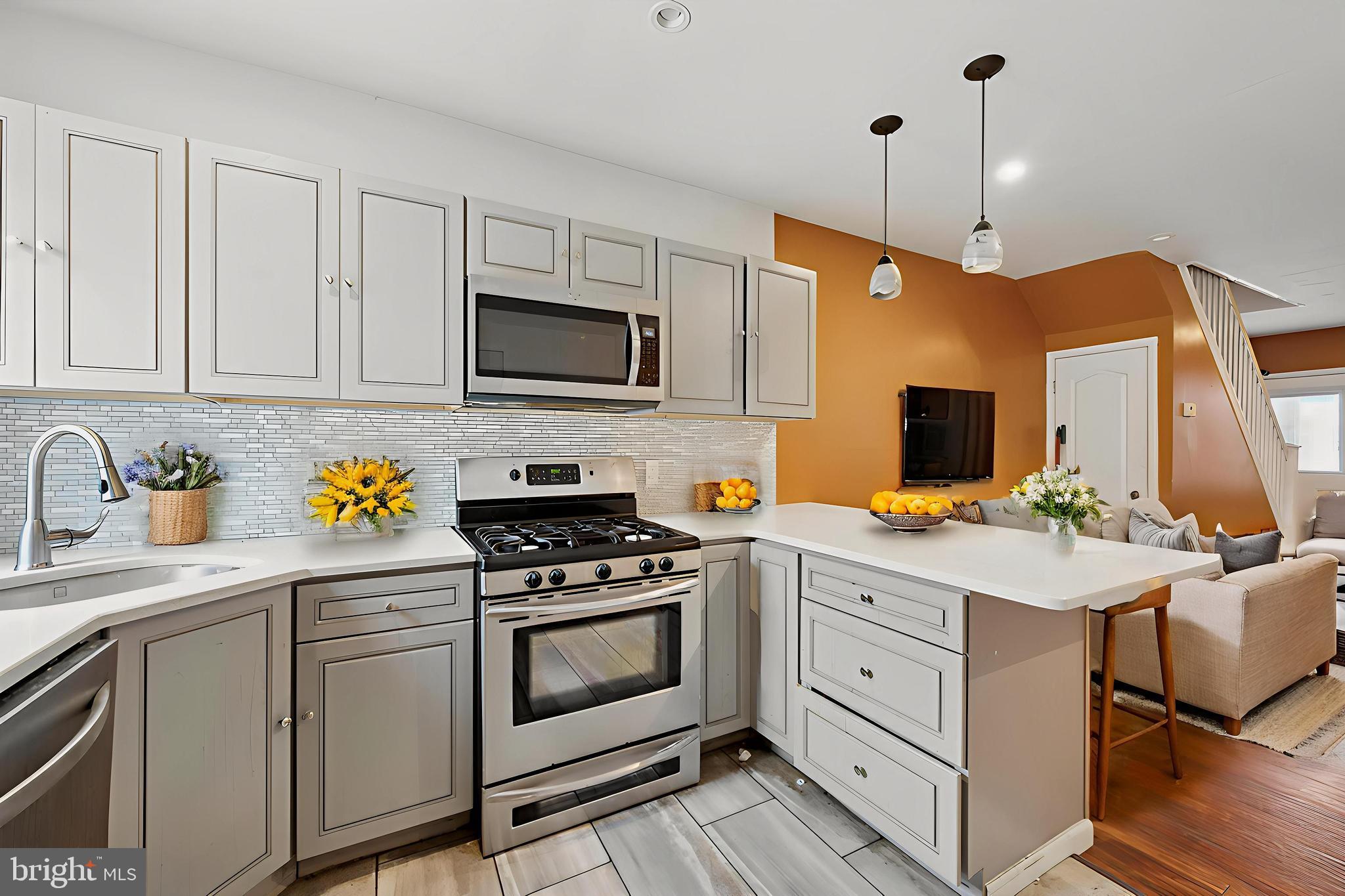 249 West Calvert Street Philadelphia, PA 19120 - Photo 2 of 25 a kitchen with stainless steel appliances white cabinets and a stove top oven