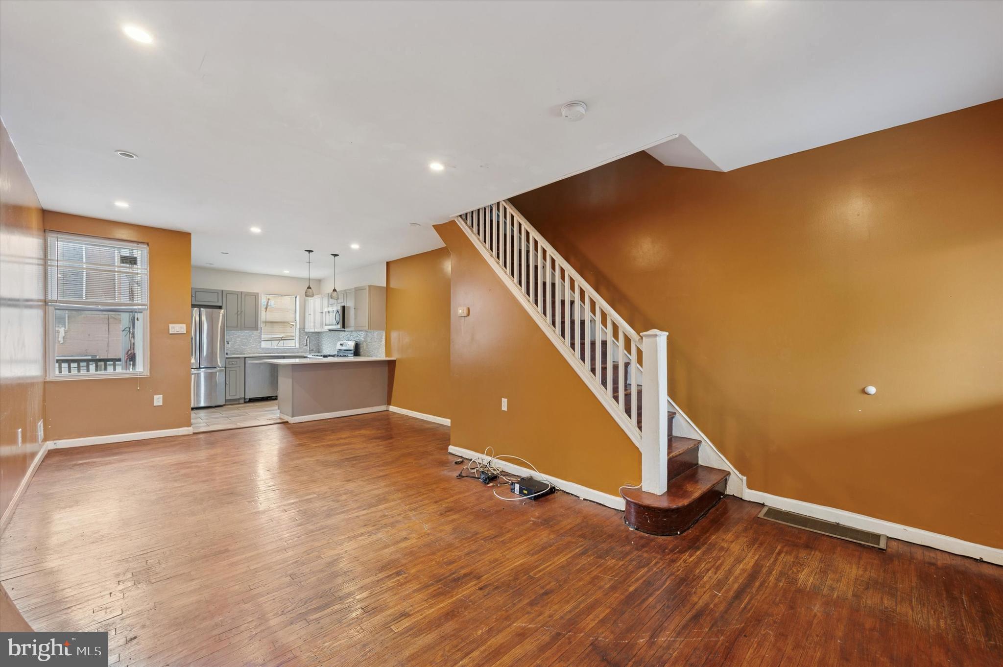 249 West Calvert Street Philadelphia, PA 19120 - Photo 4 of 25 a view of an empty room with wooden floor and stairs