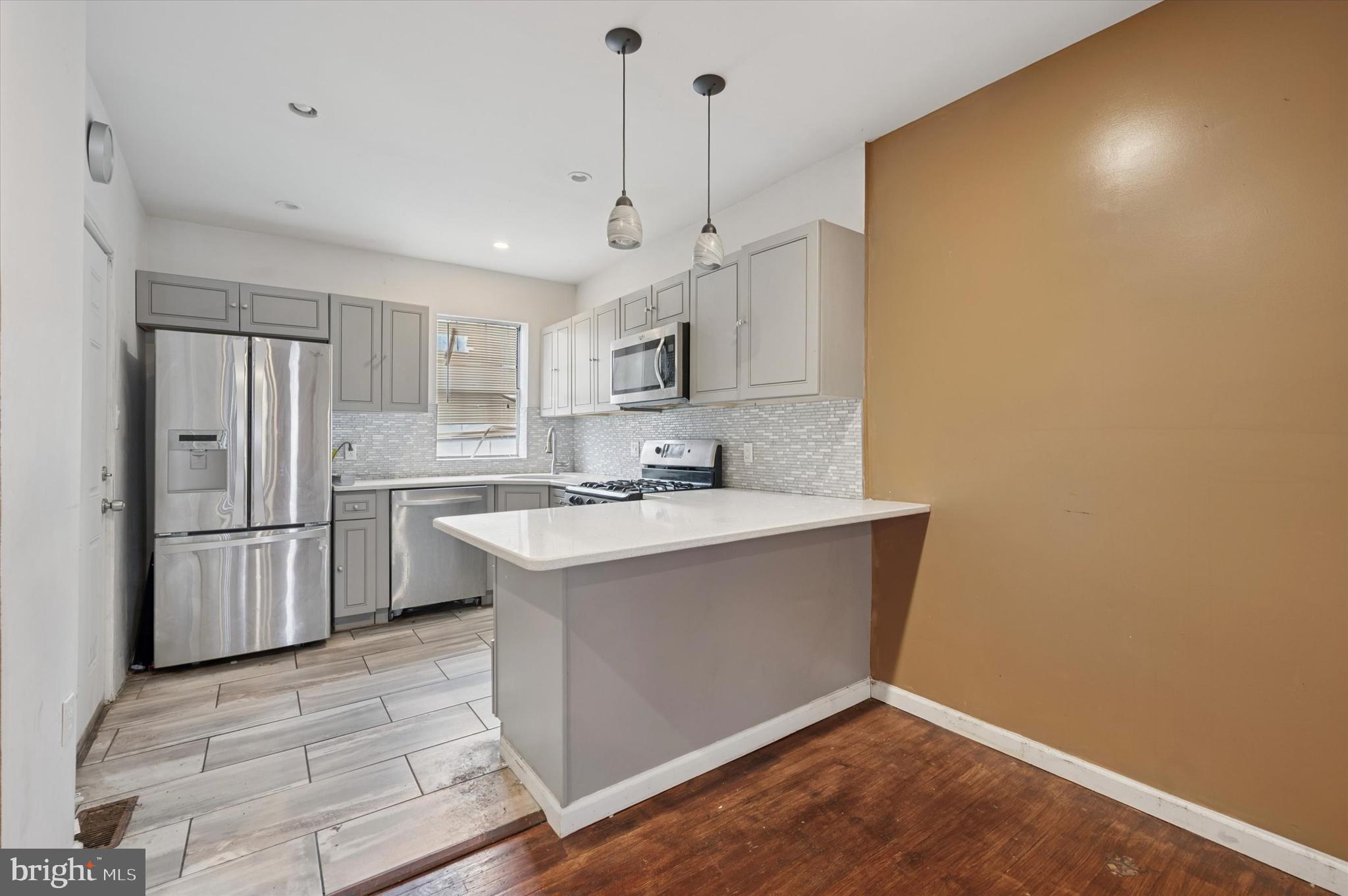 249 West Calvert Street Philadelphia, PA 19120 - Photo 9 of 25 a kitchen with stainless steel appliances a sink a stove a refrigerator and cabinets