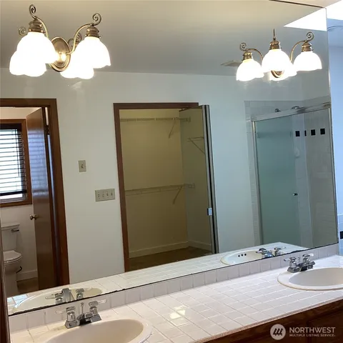 a bathroom with a sink vanity and a mirror