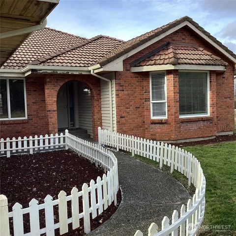 a front view of a house with a garden