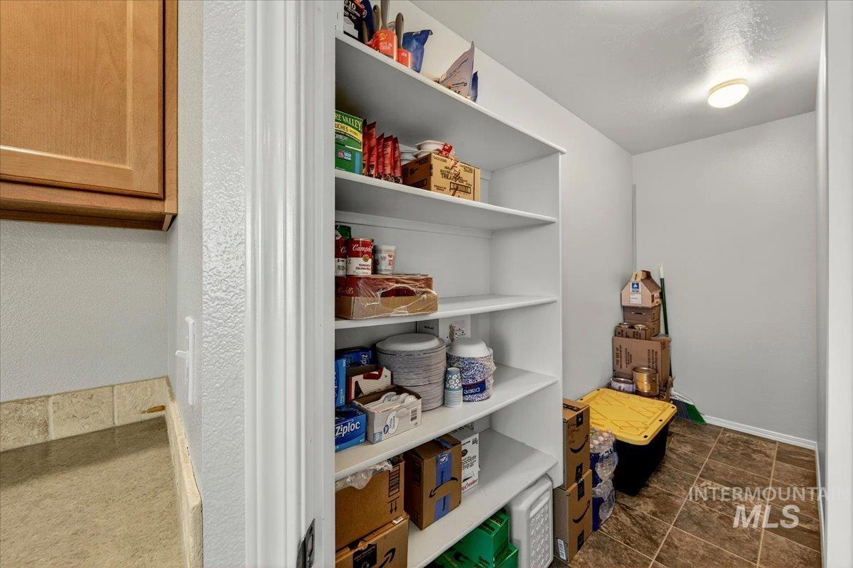 1555 Condor Drive Middleton, ID 83644 - Photo 11 of 50 Dedicated pantry featuring multiple white built-in shelves, recessed lighting, and tile flooring