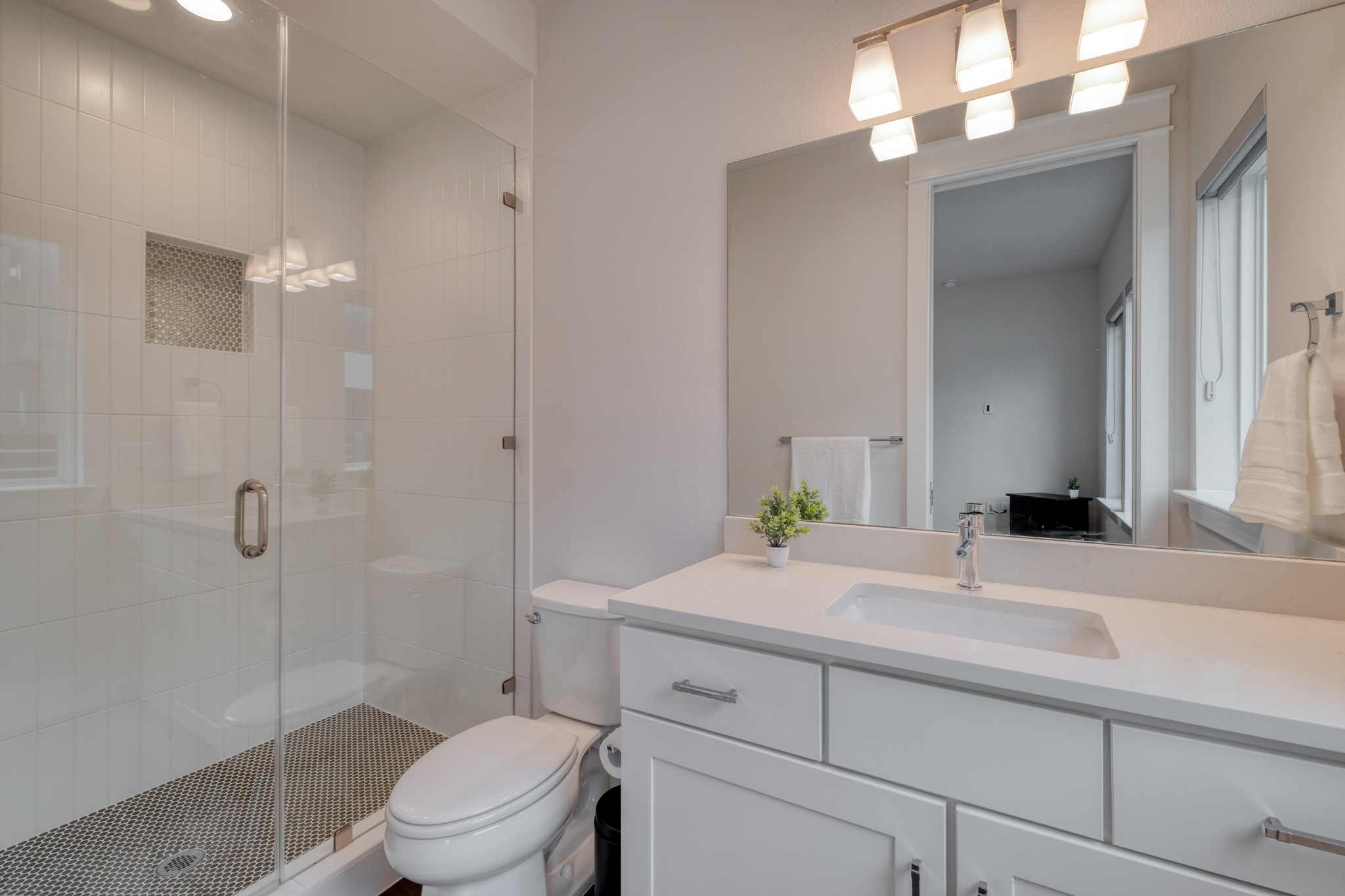 5002 Pecan Springs Road, Unit 7 Austin, TX 78723 - Photo 7 of 34 The private bathroom on the first floor is finished with neutral tile and modern fixtures for a consistent look across all three levels