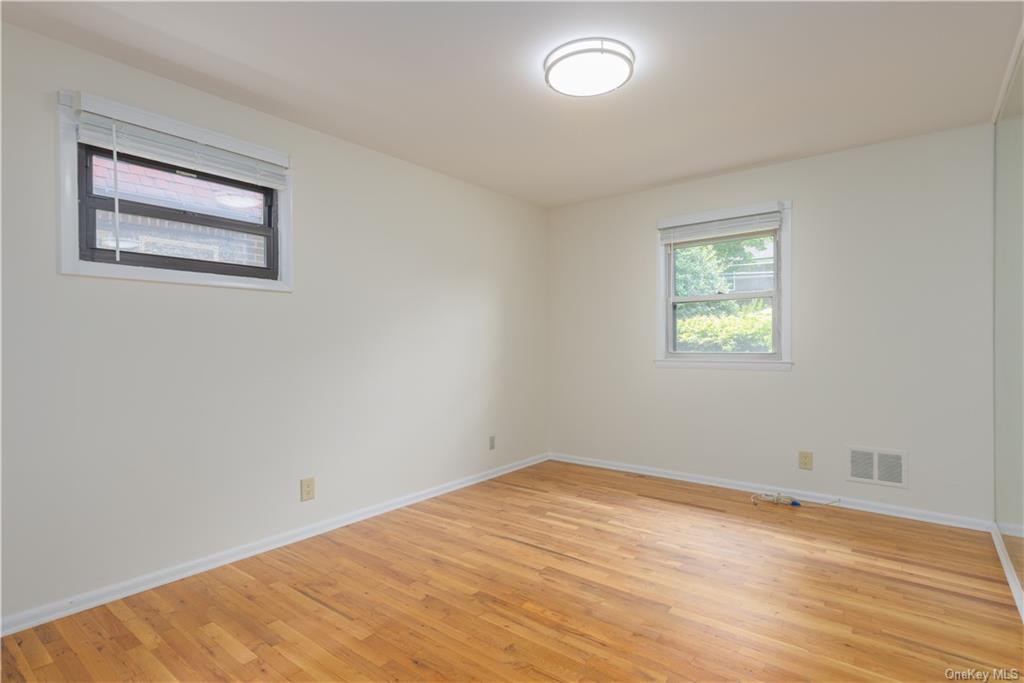 55 East Devonia Avenue, Unit 1 Mount Vernon, NY 10552 - Photo 13 of 24 a view of empty room with wooden floor and fan
