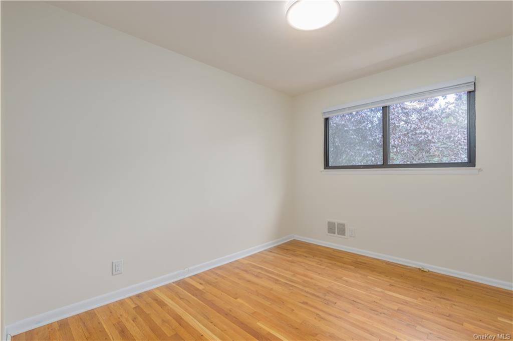 55 East Devonia Avenue, Unit 1 Mount Vernon, NY 10552 - Photo 14 of 24 a view of empty room with wooden floor and fan