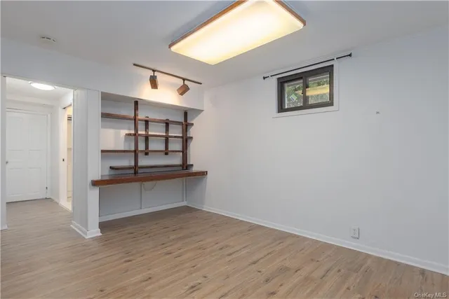 a view of a room with wooden floor and window
