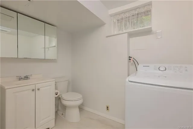 a bathroom with a toilet sink and vanity