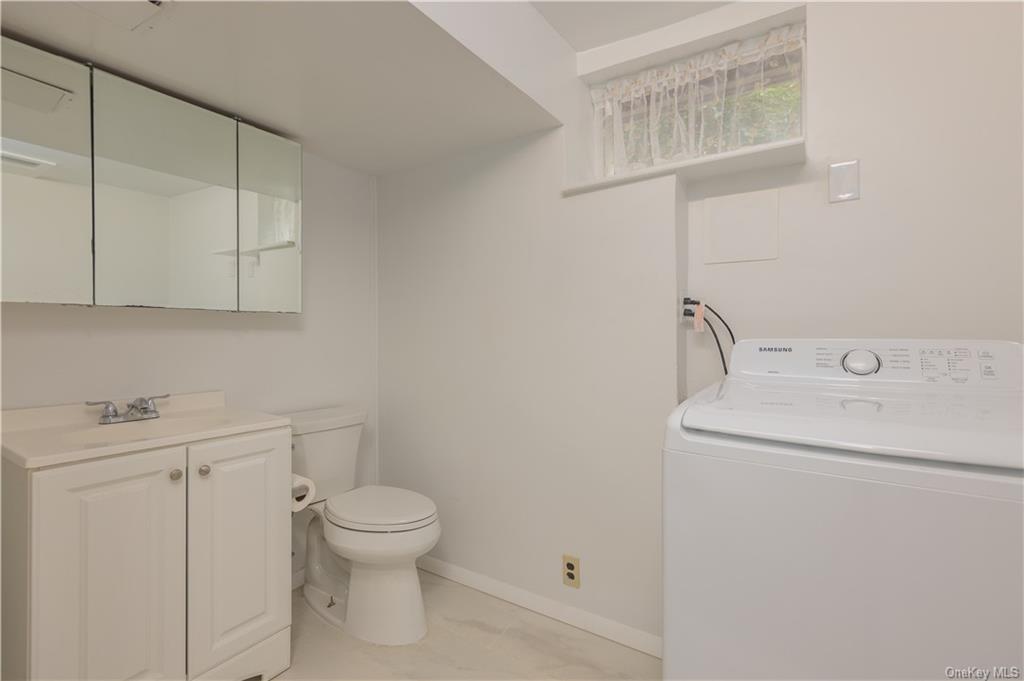 55 East Devonia Avenue, Unit 1 Mount Vernon, NY 10552 - Photo 18 of 24 a bathroom with a toilet sink and vanity