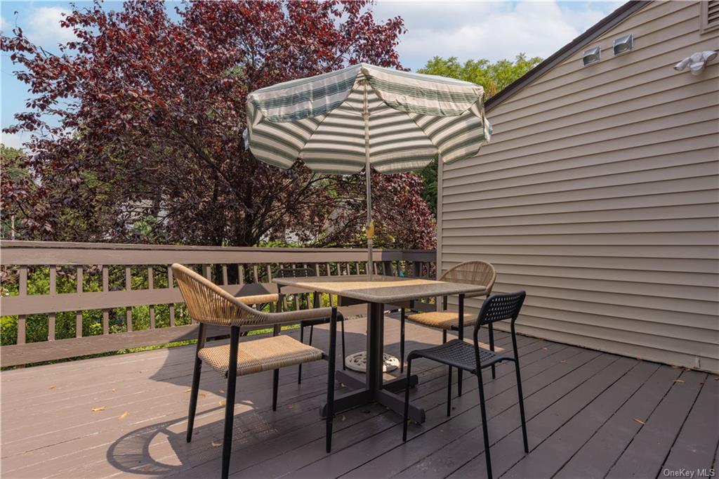 55 East Devonia Avenue, Unit 1 Mount Vernon, NY 10552 - Photo 21 of 24 a table and chairs in front of a house