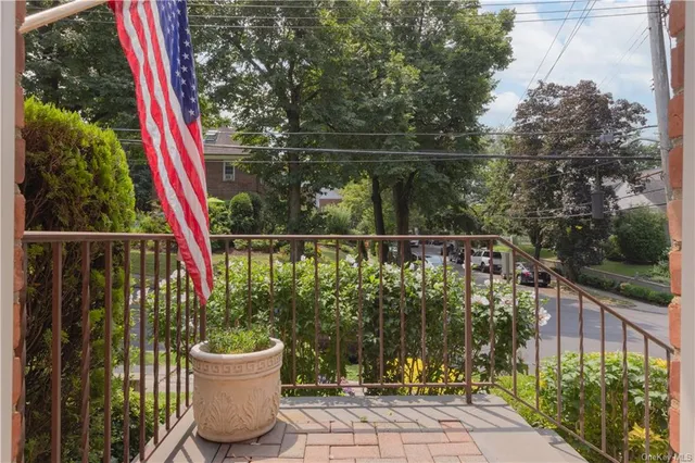 a view of a chair and table on the wooden deck