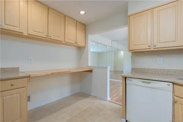 a kitchen with granite countertop white cabinets and a sink