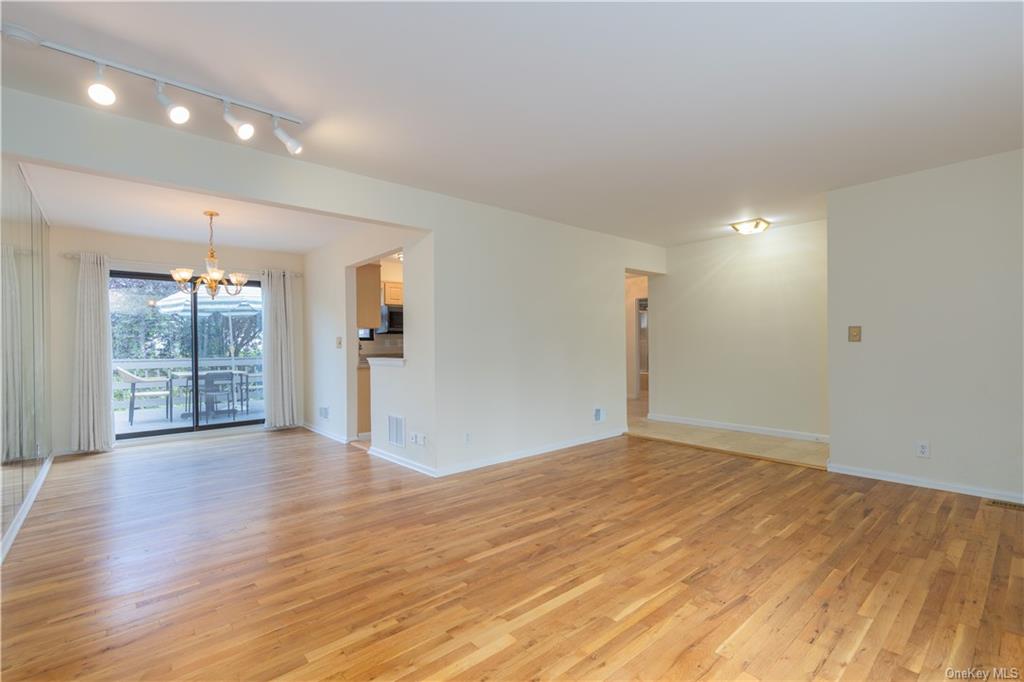 55 East Devonia Avenue, Unit 1 Mount Vernon, NY 10552 - Photo 9 of 24 a view of an empty room with wooden floor and a window