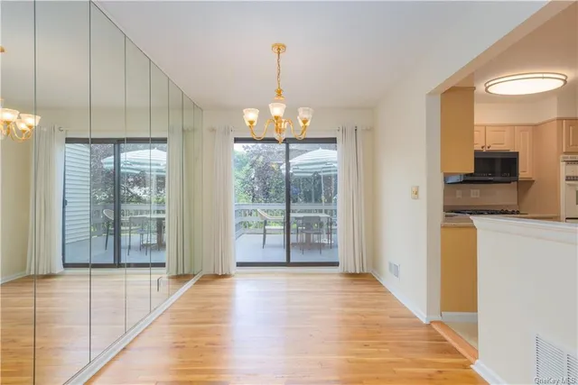 a view of a room with wooden floor and a window