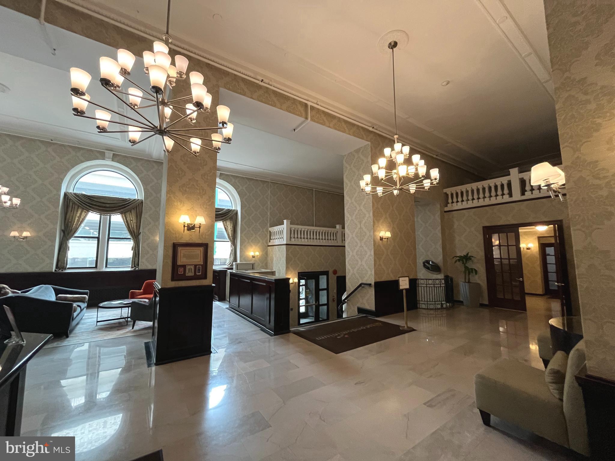 1324 Locust Street, Unit 501 Philadelphia, PA 19107 - Photo 2 of 8 a view of a dining room with furniture a chandelier and wooden floor