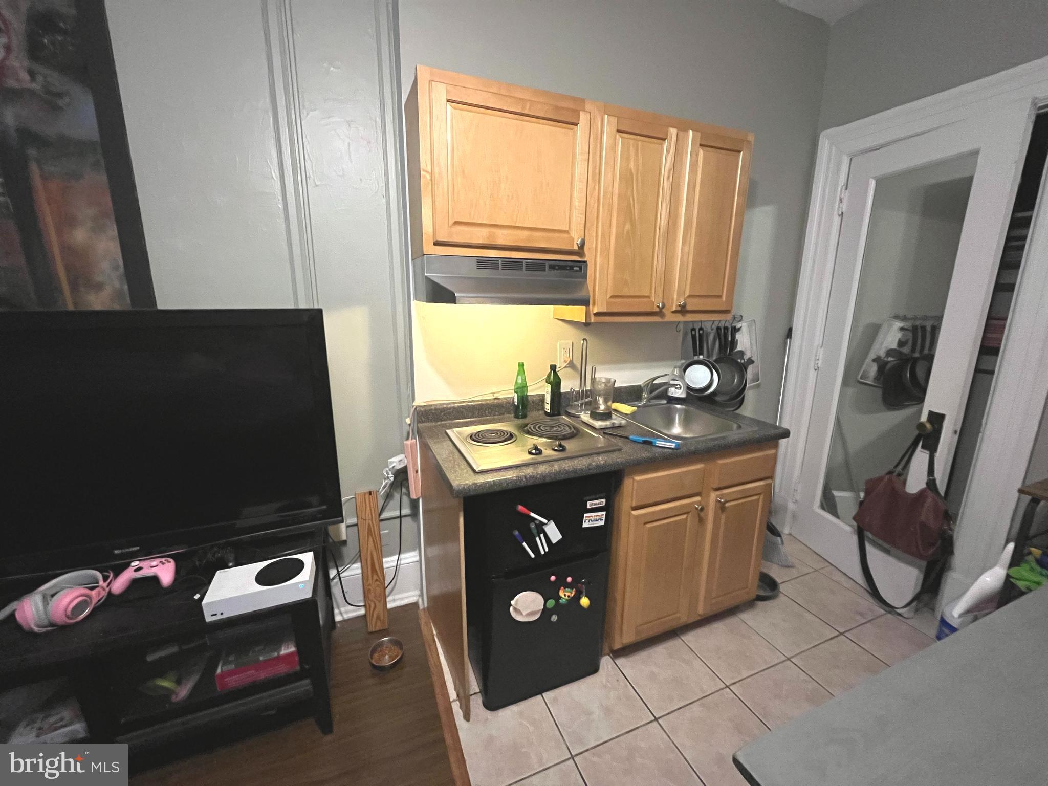 1324 Locust Street, Unit 501 Philadelphia, PA 19107 - Photo 3 of 8 a kitchen with stainless steel appliances granite countertop a sink and a stove