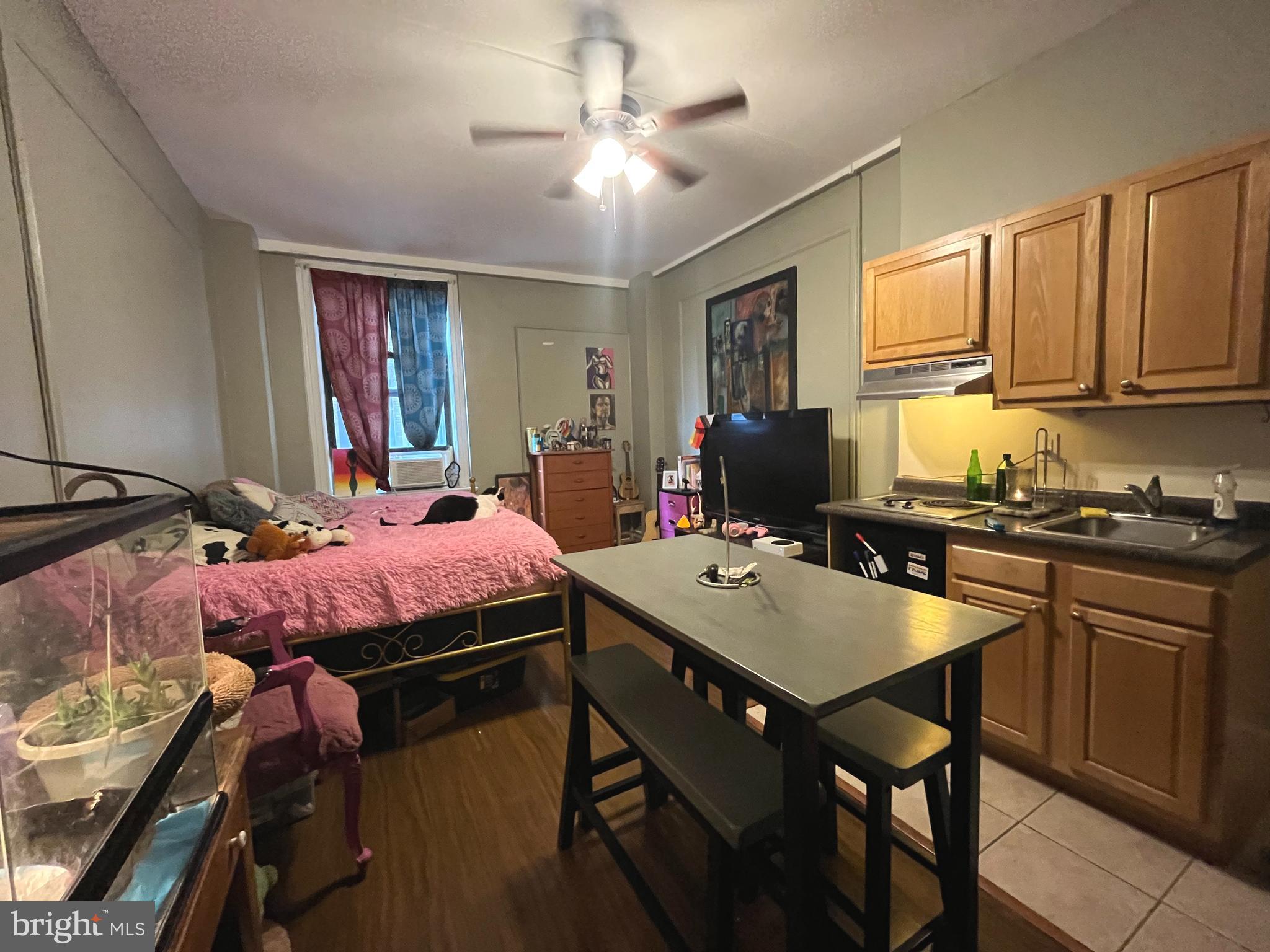 1324 Locust Street, Unit 501 Philadelphia, PA 19107 - Photo 4 of 8 a bedroom with a bed and a table