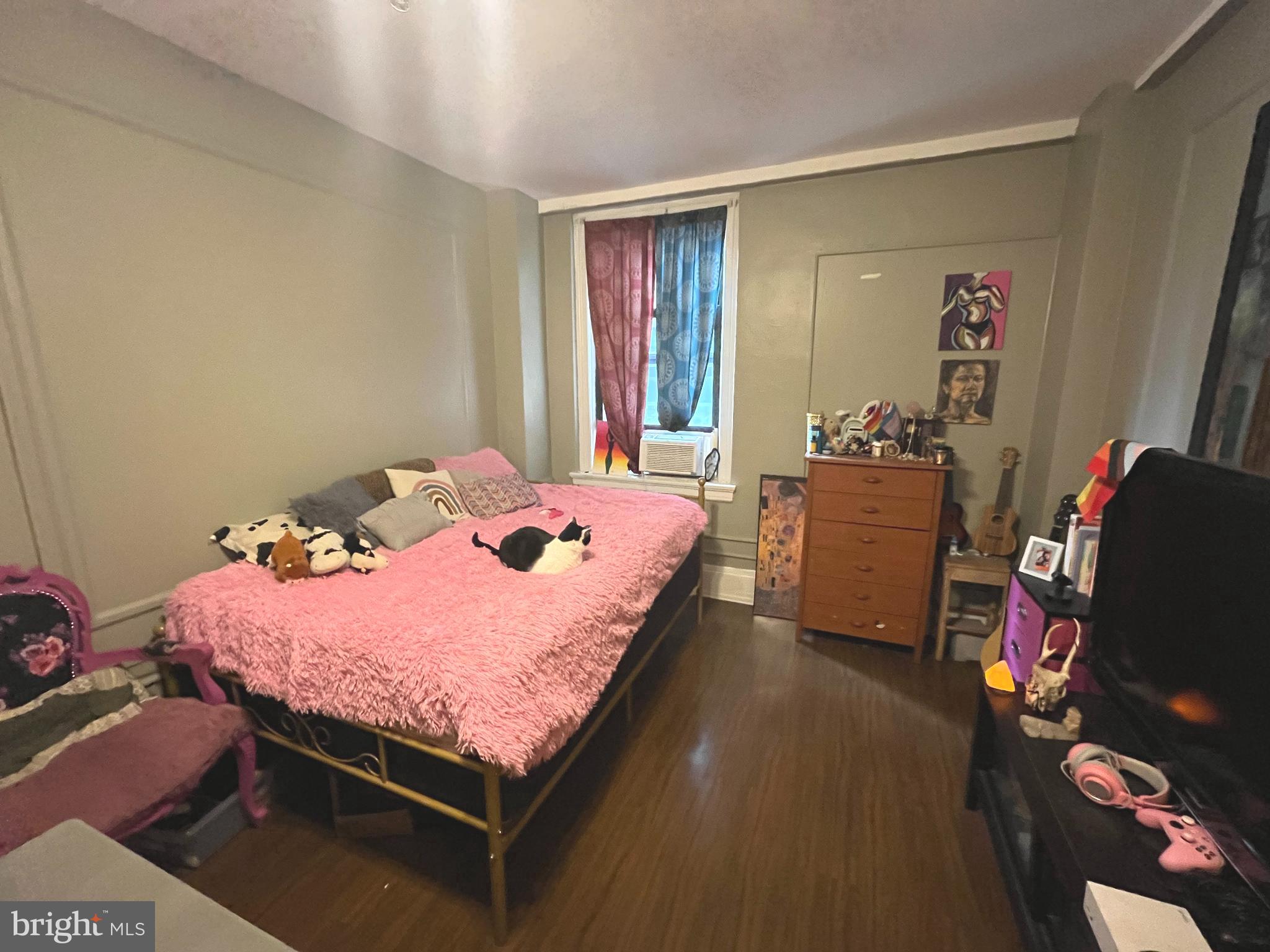 1324 Locust Street, Unit 501 Philadelphia, PA 19107 - Photo 5 of 8 a bed sitting in a bedroom next to a window