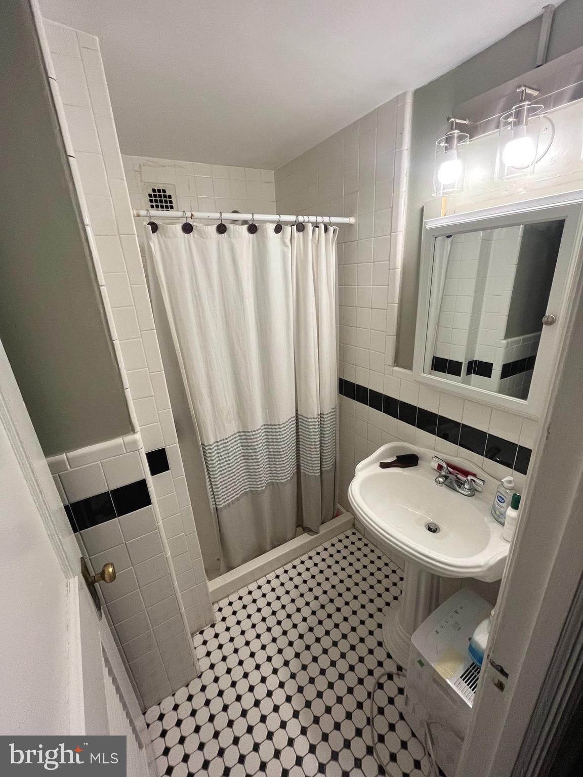 1324 Locust Street, Unit 501 Philadelphia, PA 19107 - Photo 8 of 8 a bathroom with a sink toilet and shower