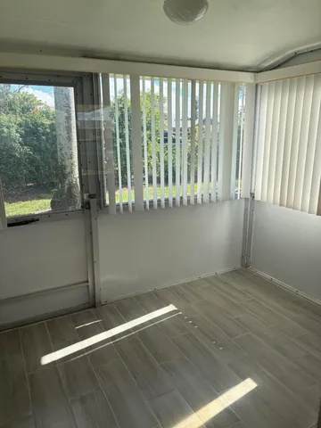 a view of a room with wooden floor and windows