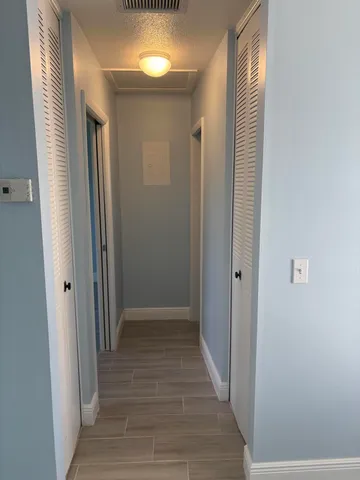 a view of a hallway with wooden floor