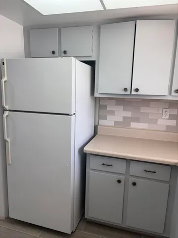 a white refrigerator freezer sitting inside of a kitchen