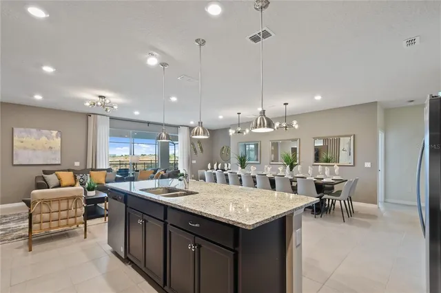 a living room with furniture ceiling fan and a floor to ceiling window