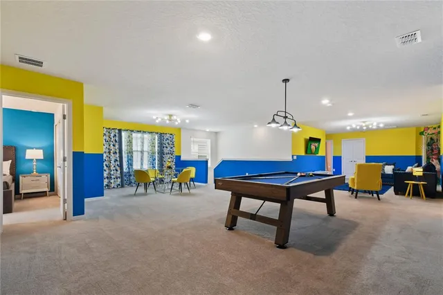 a bedroom with a bed and a dresser with wooden floor