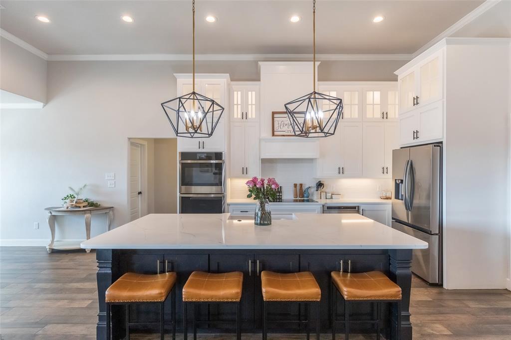 107 Kleingrass Road Abilene, TX 79606 - Photo 11 of 39 a kitchen with stainless steel appliances granite countertop a dining table chairs and chandelier