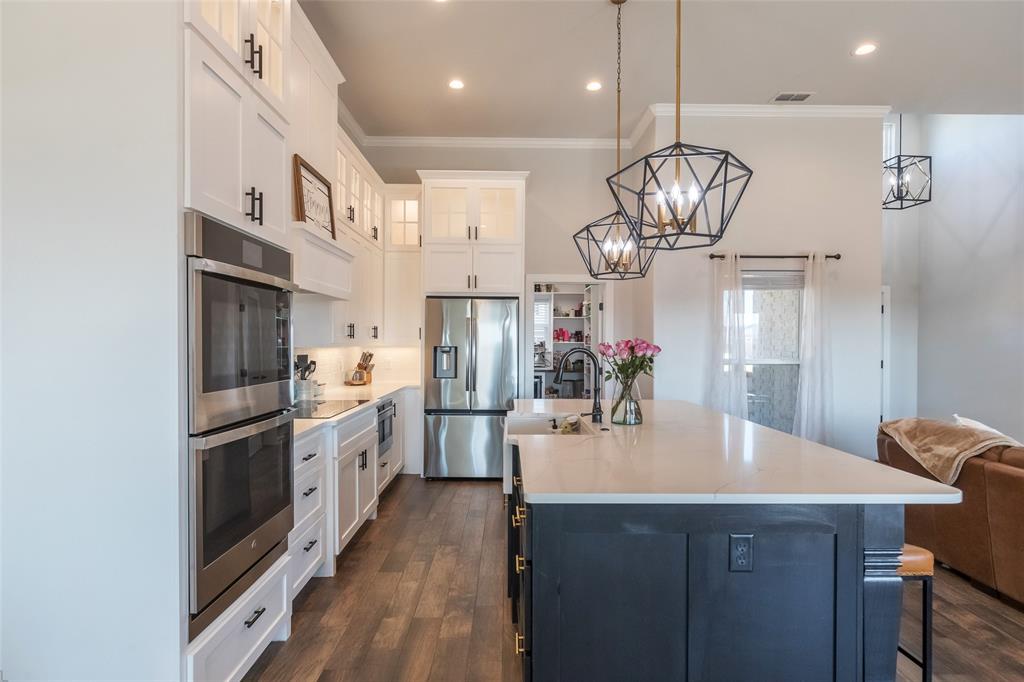 107 Kleingrass Road Abilene, TX 79606 - Photo 12 of 39 a kitchen with stainless steel appliances kitchen island a chandelier