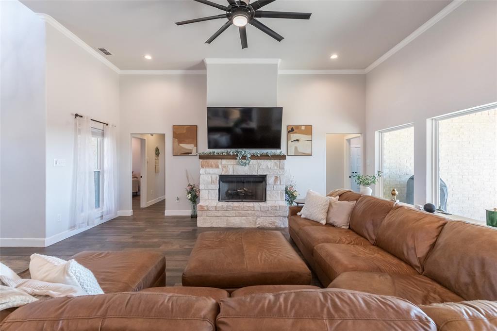107 Kleingrass Road Abilene, TX 79606 - Photo 10 of 39 a living room with furniture a flat screen tv and a fireplace