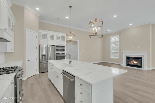 a kitchen with stainless steel appliances a sink stove and refrigerator