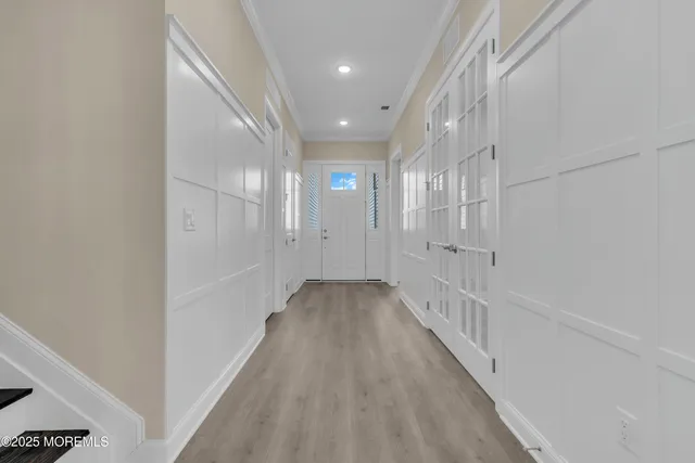 a view of a hallway with wooden floor