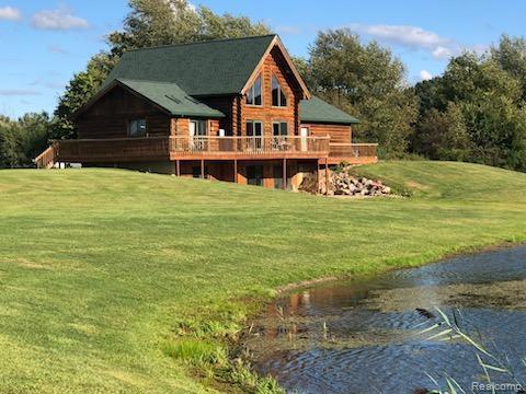 10374 Wilson Road Otisville, MI 48463 - Photo 7 of 99 Rear view of house featuring a yard and a deck with water view
