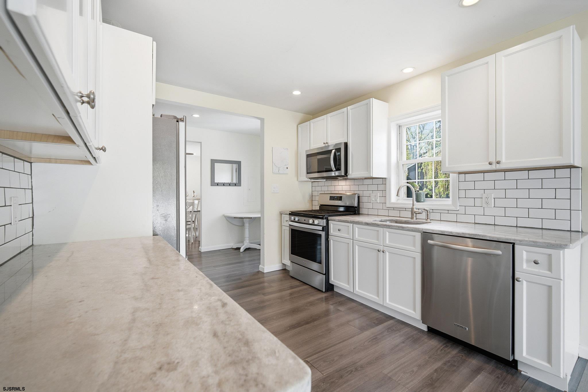 395 1st Street Northfield, NJ 08225 - Photo 13 of 54 a kitchen with cabinets and appliances
