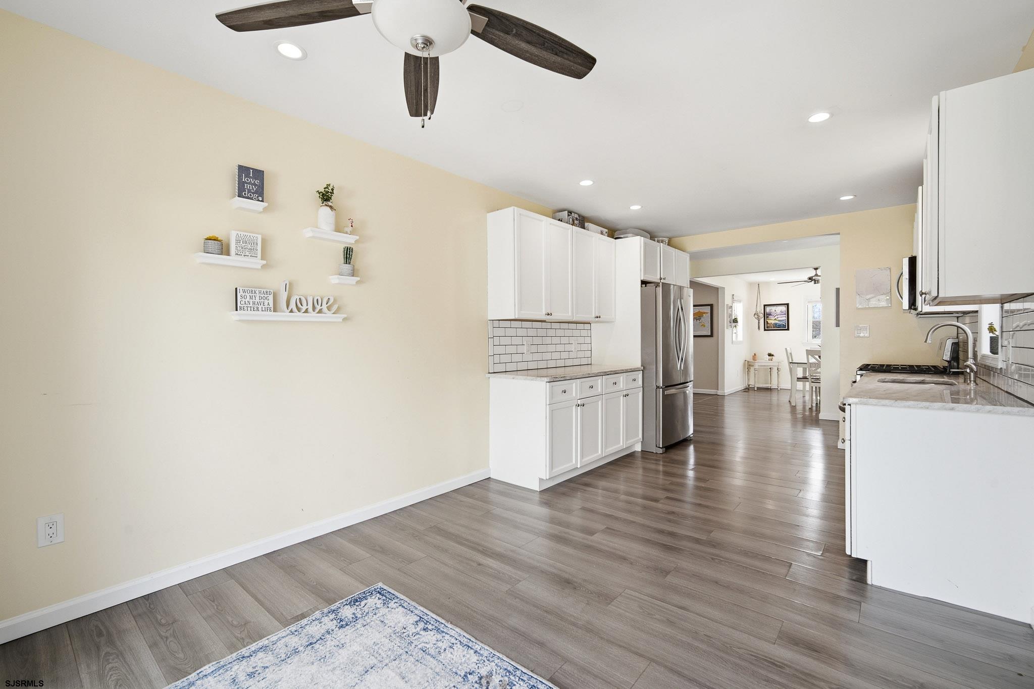 395 1st Street Northfield, NJ 08225 - Photo 15 of 54 a kitchen with stainless steel appliances granite countertop a refrigerator and a stove top oven