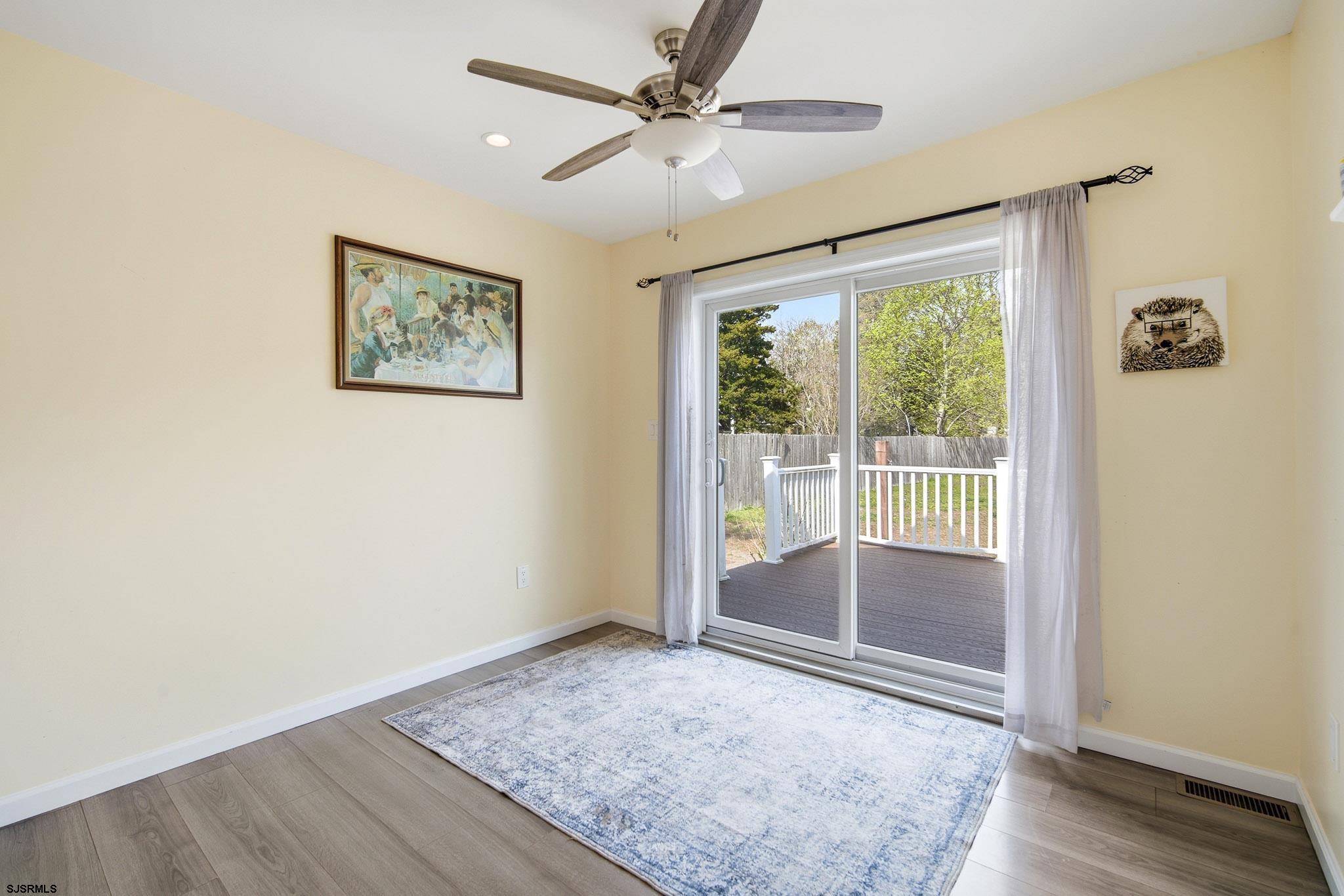 395 1st Street Northfield, NJ 08225 - Photo 16 of 54 an empty room with fan and windows
