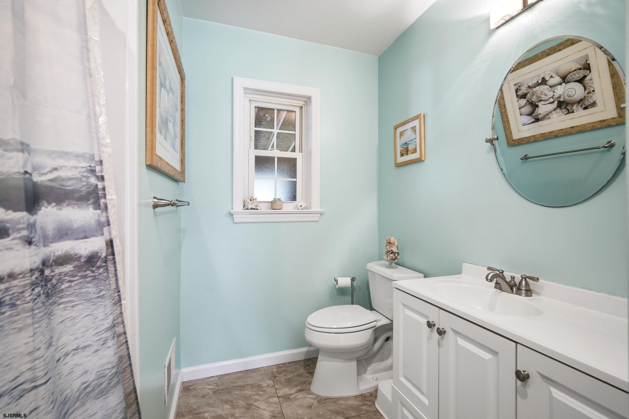 395 1st Street Northfield, NJ 08225 - Photo 19 of 54 a bathroom with a toilet and a sink