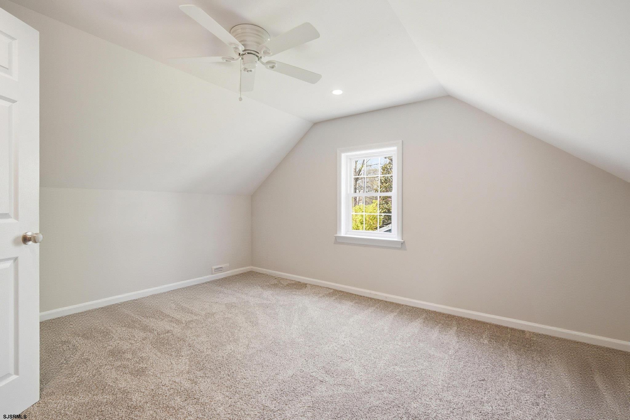 395 1st Street Northfield, NJ 08225 - Photo 23 of 54 an empty room with a window and a fan